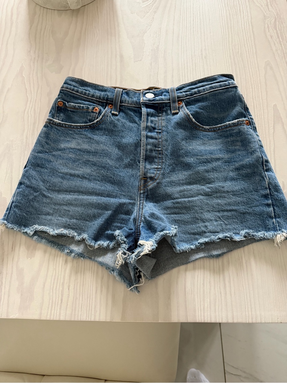 High-Rise Frayed Hem Denim Shorts in Blue